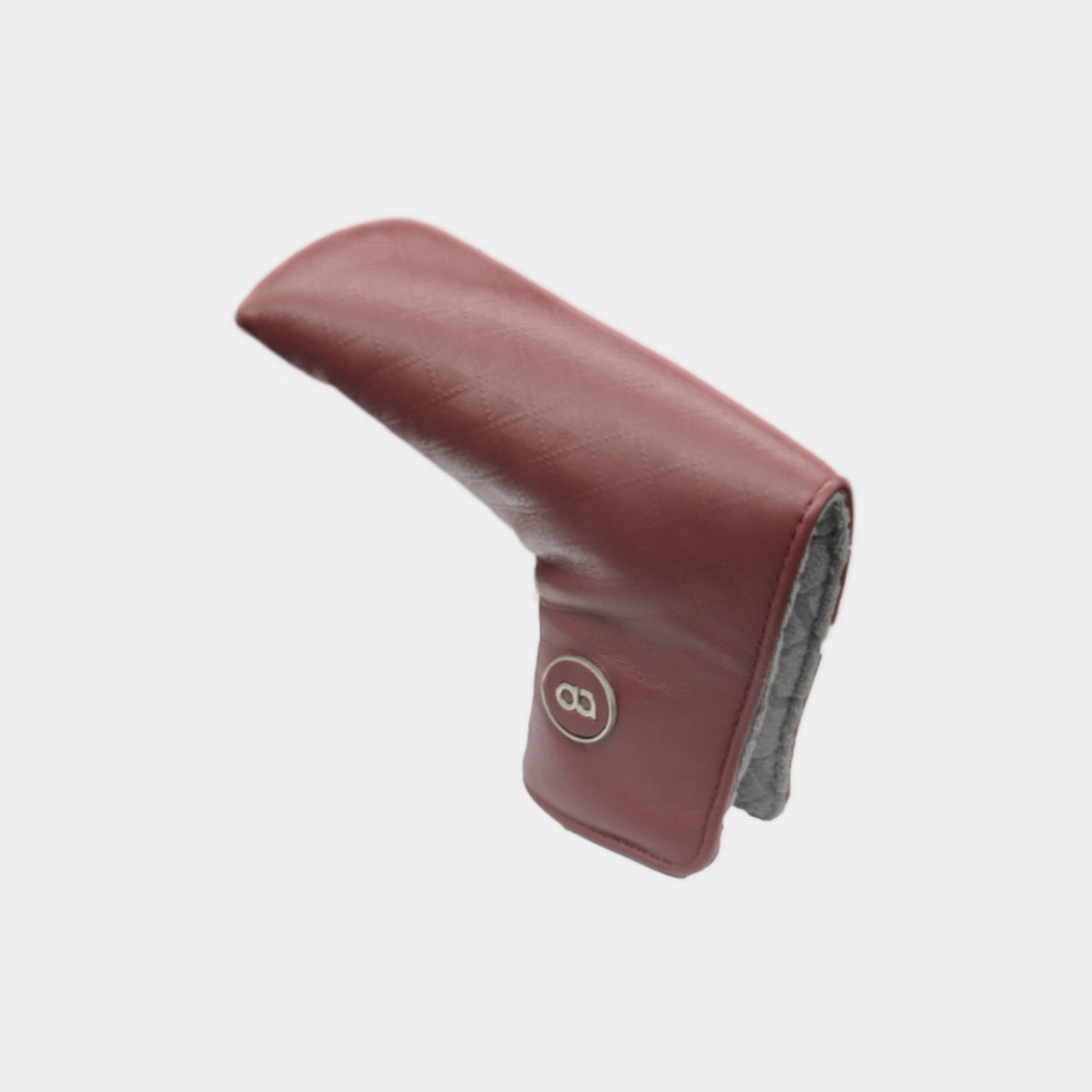 A burgundy leather golf club putter headcover with a gray fleece lining and a circular logo badge, shown on a light gray background.