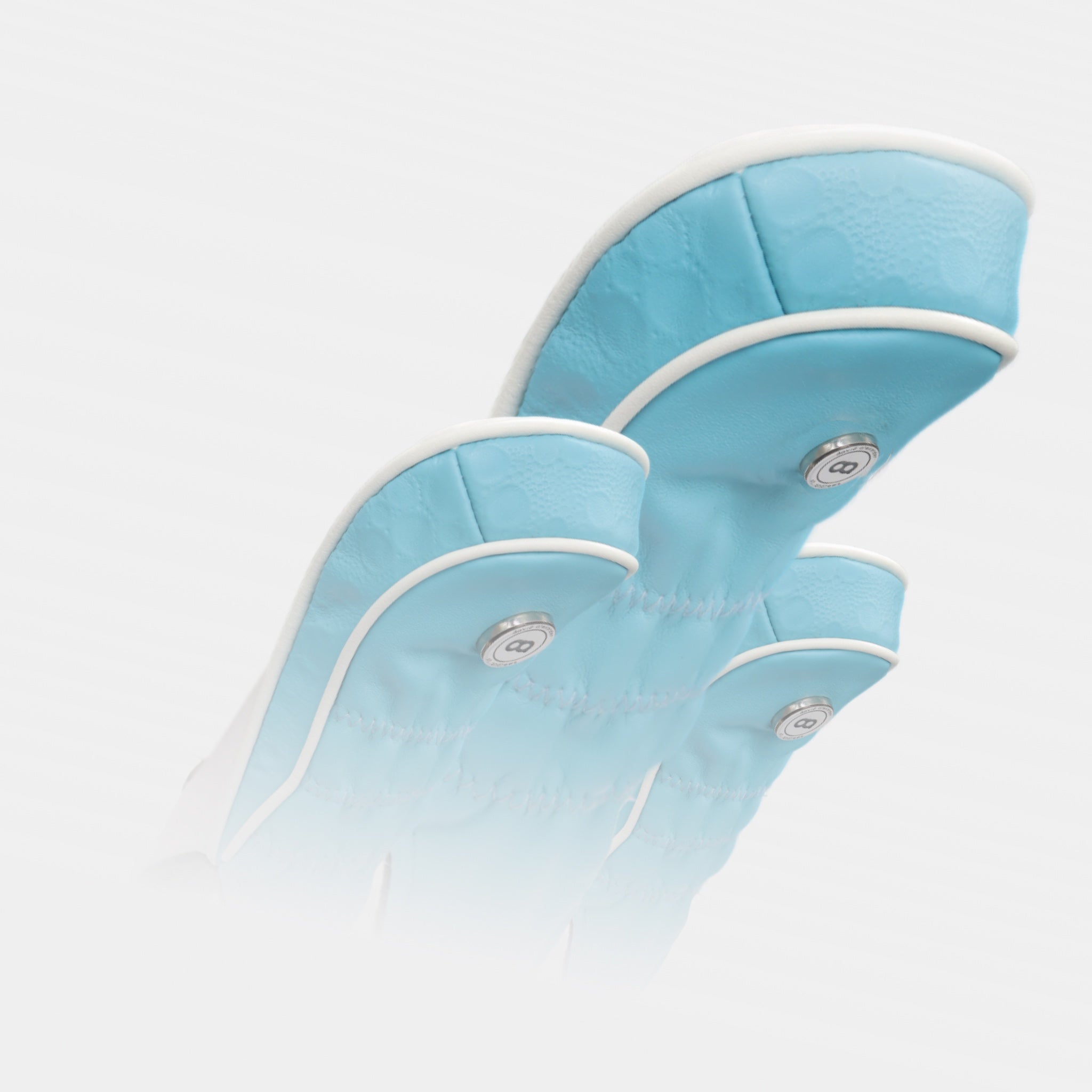 A set of aqua blue leather golf club headcovers by Dave Alexander