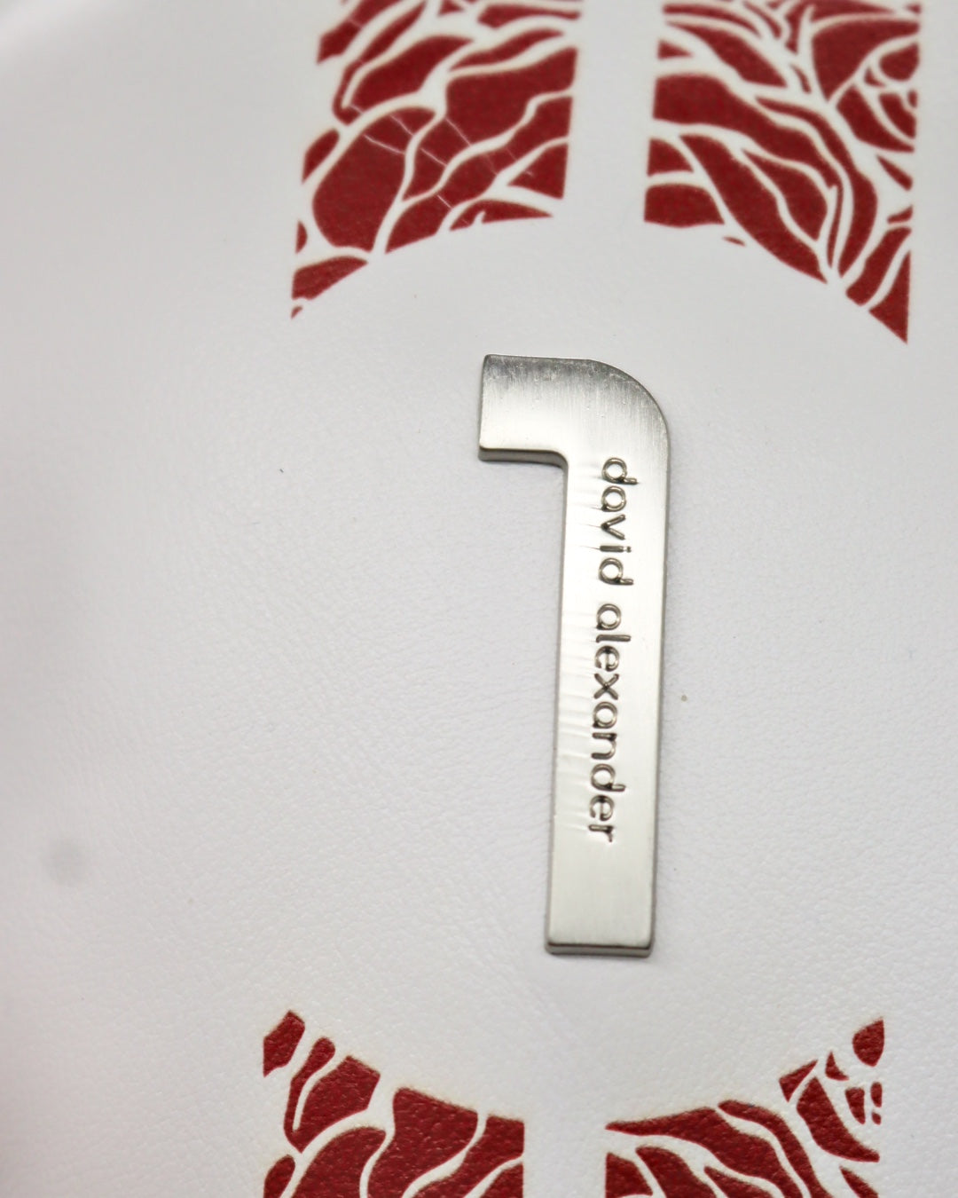 Chrome insignia on white and crimson leather driver headcover by David Alexander