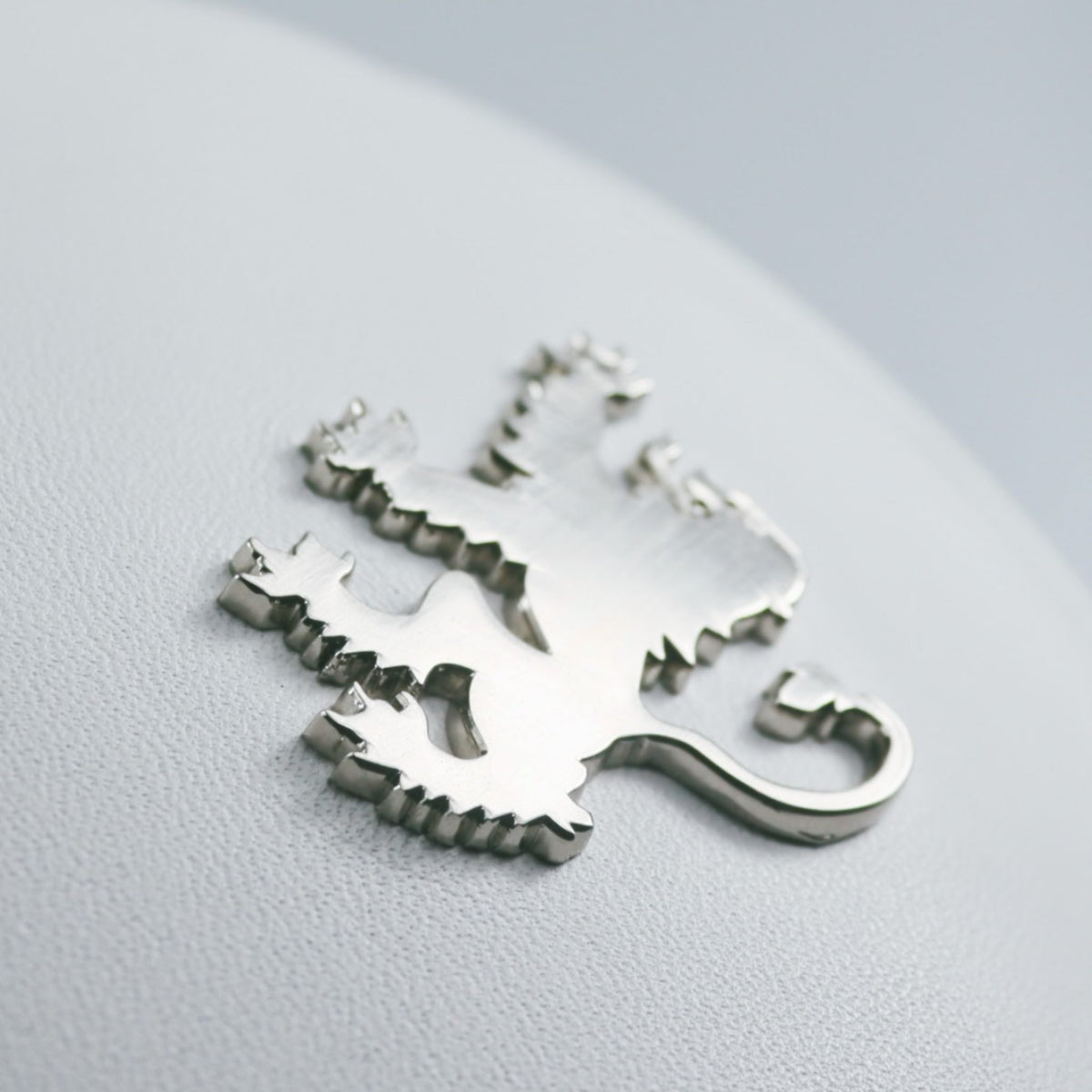 Chrome Scottish rampant lion from the cover of a leather headcover by David Alexander