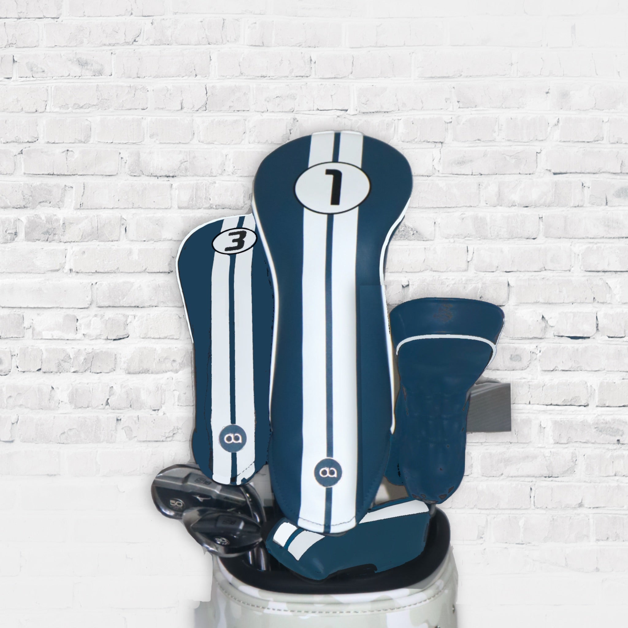 A set of Madeira blue leather golf club headcovers with racing stripes by Dave Alexander