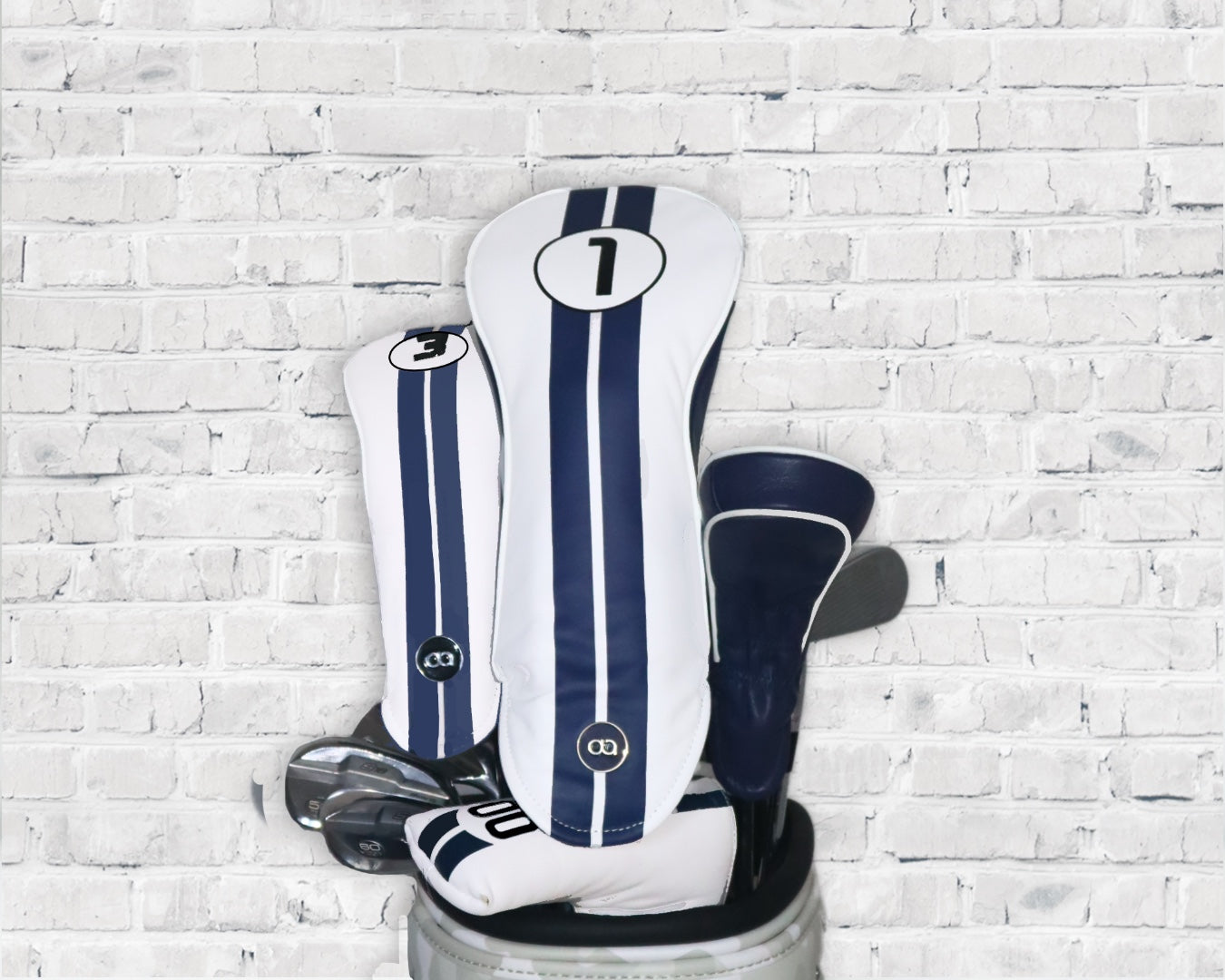 White and blue Racing Line leather golf club headcover set by David Alexander against a white wall background.