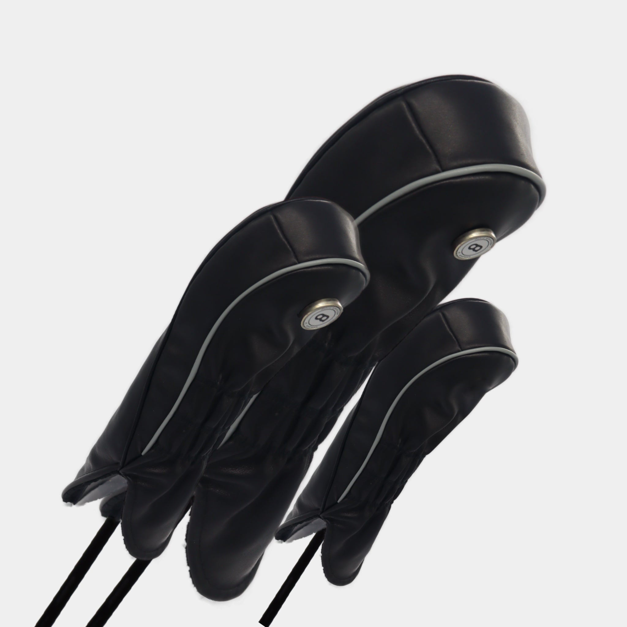 A set of black leather golf club headcovers with racing stripes by Dave Alexander