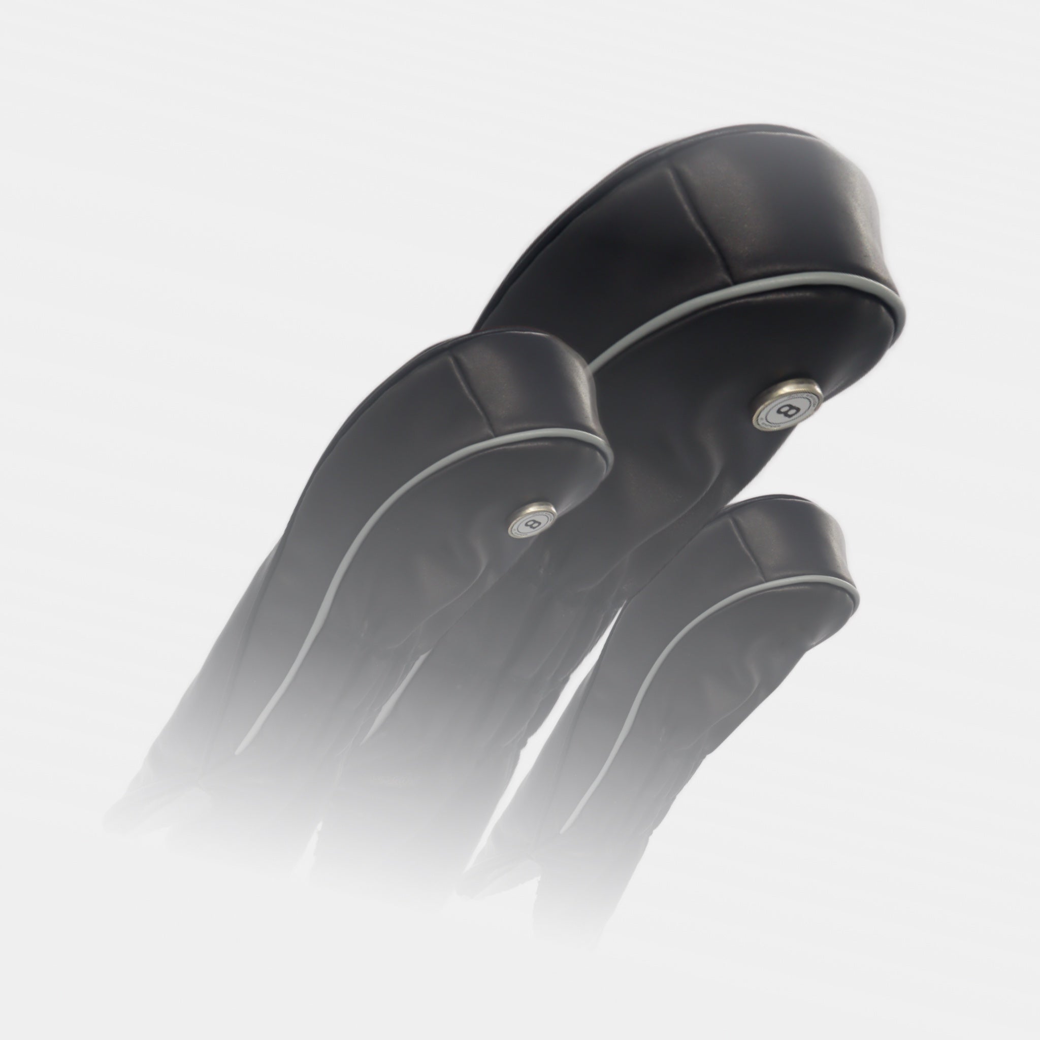 A set of black leather golf club headcovers with racing stripes by Dave Alexander