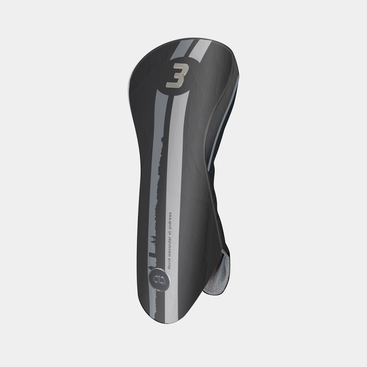 A black and grey leather golf club headcover with a vertical St. Andrews cityscape stripe design and a chrome number 3 on the upper portion shown on a light gray background.