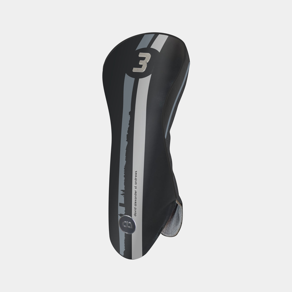 A black and grey leather golf club headcover with a vertical St. Andrews cityscape stripe design and a chrome number 3 on the upper portion shown on a light gray background.