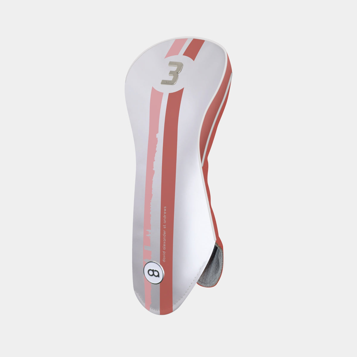 A white and terracotta golf club headcover with a vertical St. Andrews cityscape stripe design and a chrome number 3 on the upper portion shown on a light gray background.