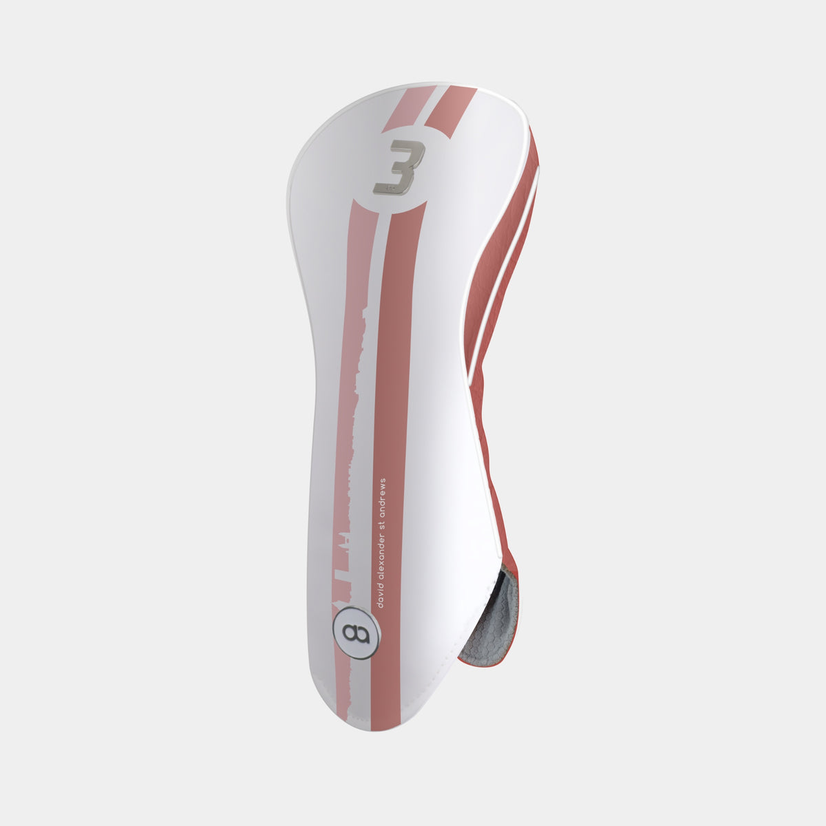 A white and terracotta golf club headcover with a vertical St. Andrews cityscape stripe design and a chrome number 3 on the upper portion shown on a light gray background.