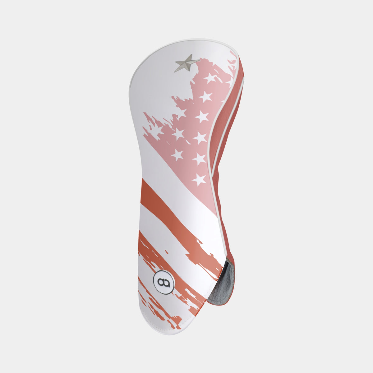 A golf club headcover featuring a distressed American flag design with pink and terracotta stripes and stars on a white background, shown against a light gray studio backdrop.