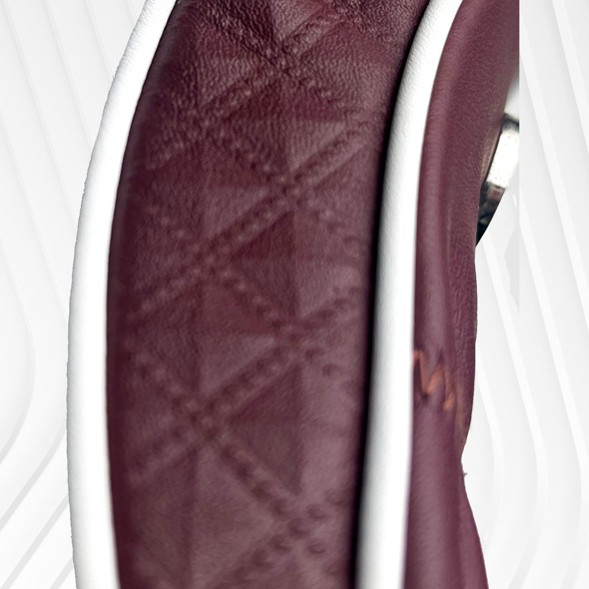 Close-up of a burgundy diamond emboss leather headcover side.