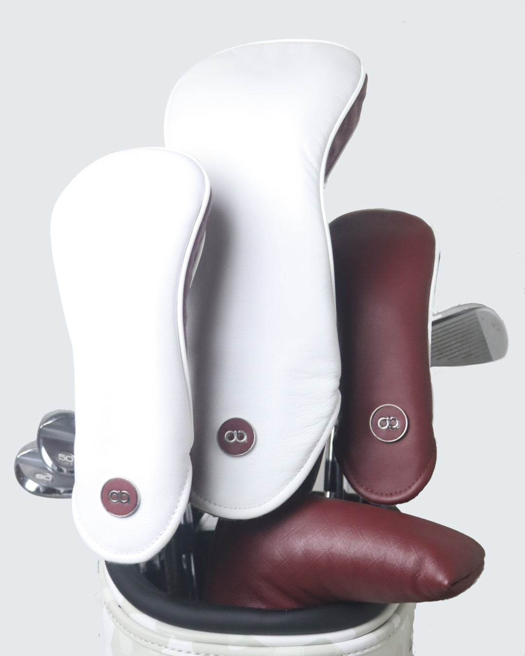 Set of white and burgundy leather fairway wood headcover by David Alexander