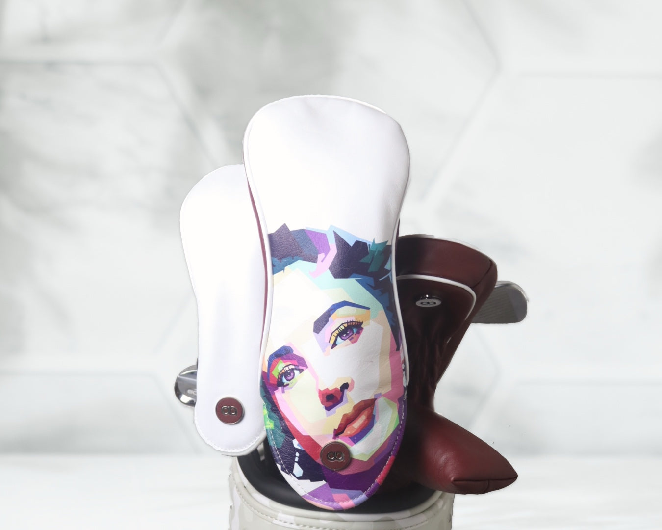 White and burgundy leather golf club headcover set with Elizabeth Taylor against a white floral background.