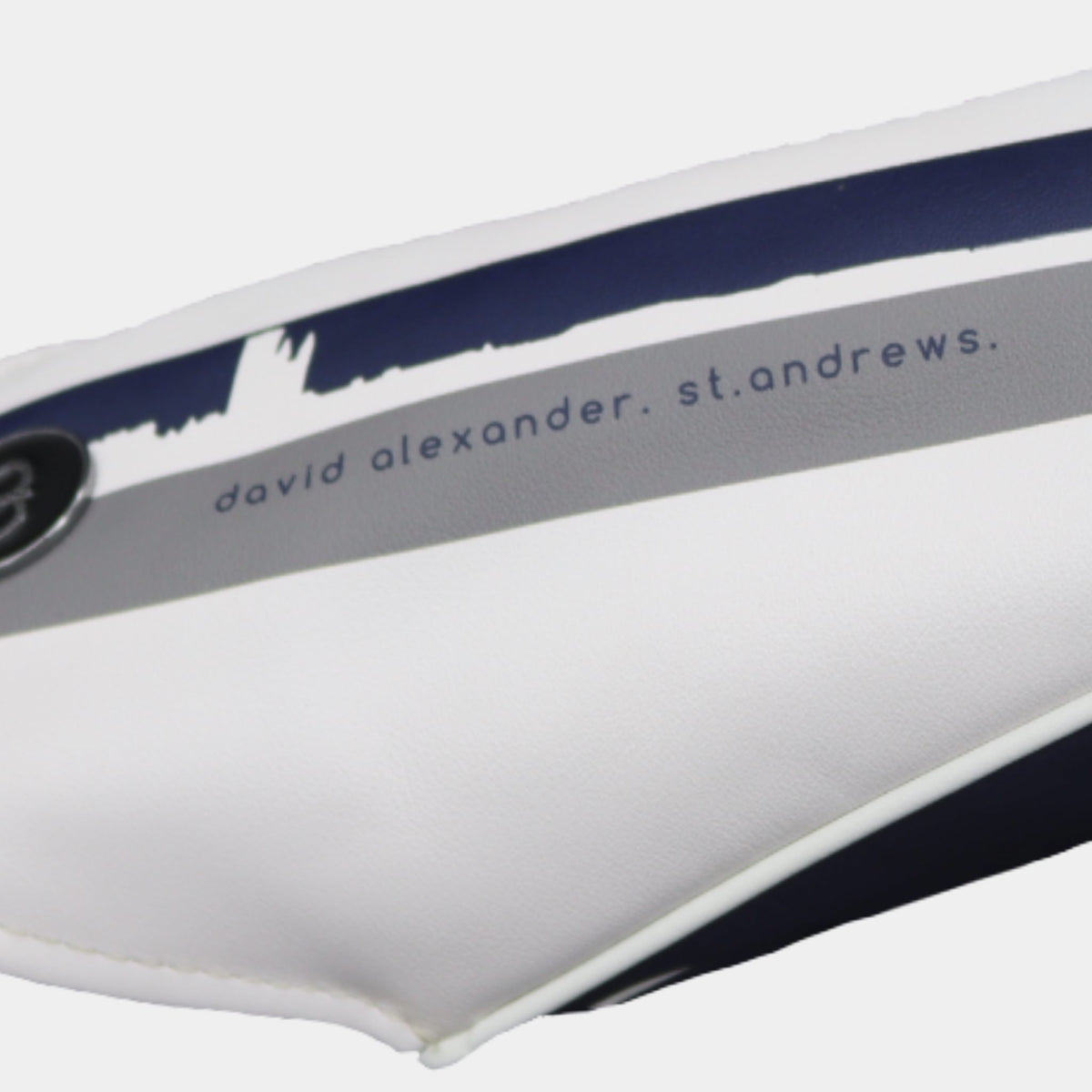 Close-up of a white golf club headcover with navy blue and gray stripes, featuring david alexander st. andrews cityscape