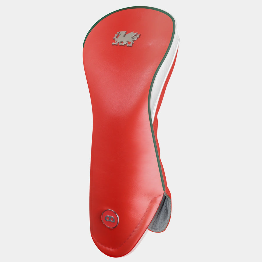 A red Wales golf club headcover featuring a chrome Welsh dragon near the top and a circular silver logo near the bottom, with a white side panel and green and white pipping