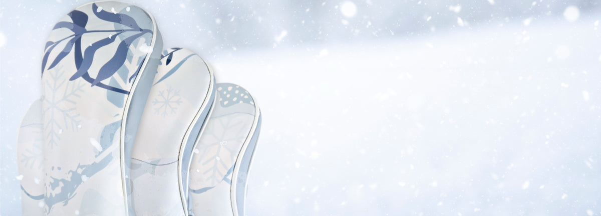 A set of leather golf club headcovers in a winter snow storm