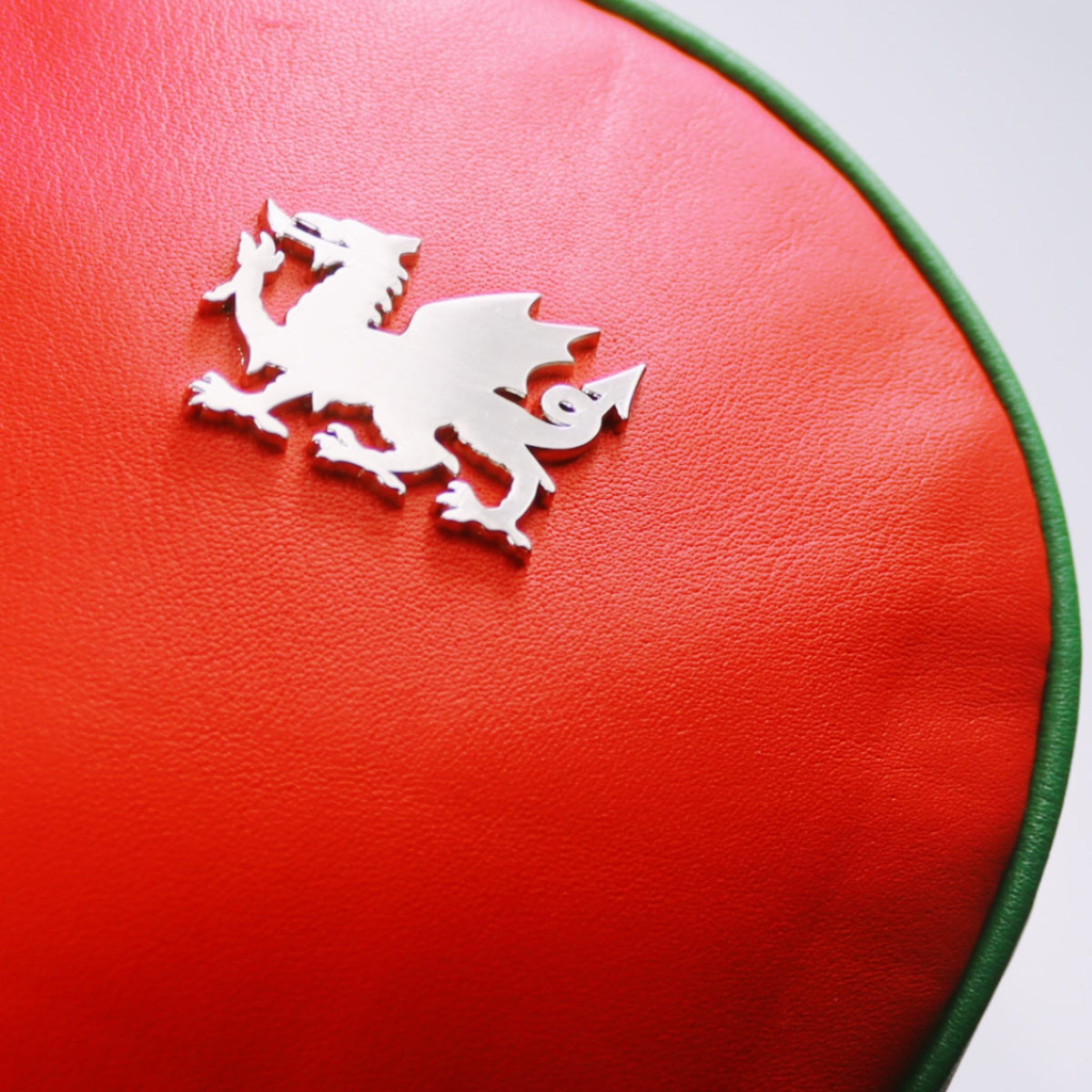 Close up of chrome Welsh dragon on red leather driver golf club headcover by David Alexander.
